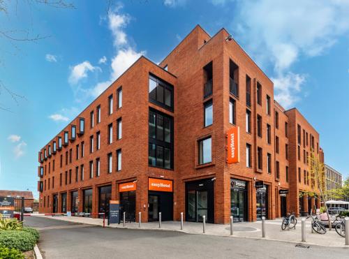 a red brick building on a city street at easyHotel Oxford in Oxford