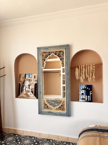 a mirror in a room with two mirrors on a wall at Riad D’AR GANne by Carole in Essaouira