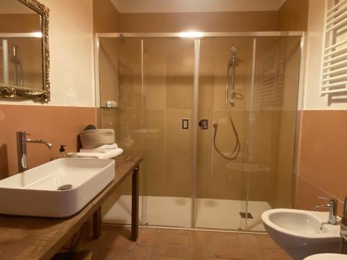 a bathroom with a shower and a sink and a tub at Tempo al Tempo in Villadeati