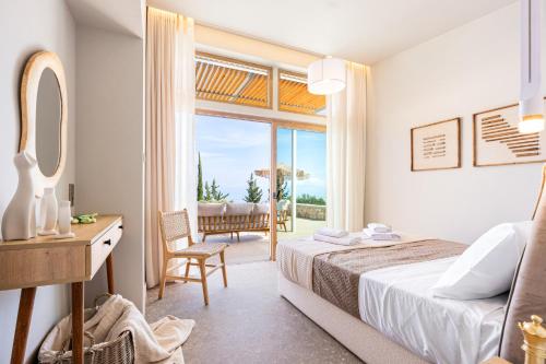 a bedroom with a bed and a table with a mirror at Veragi Boutique Villas in Lefkada
