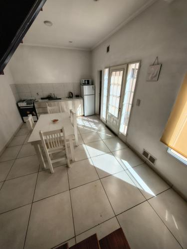 a kitchen with a table and chairs in a room at Depto Civora 4 in Villa Regina