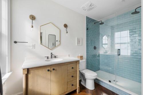 a bathroom with a sink and a toilet and a shower at 4th Floor Queen Suite Boutique hotel in Savannah