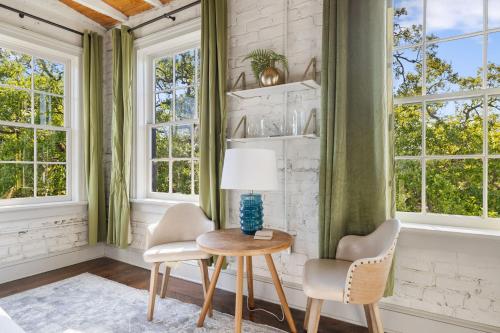 a room with two chairs and a table with a lamp at 4th Floor Queen Suite Boutique hotel in Savannah