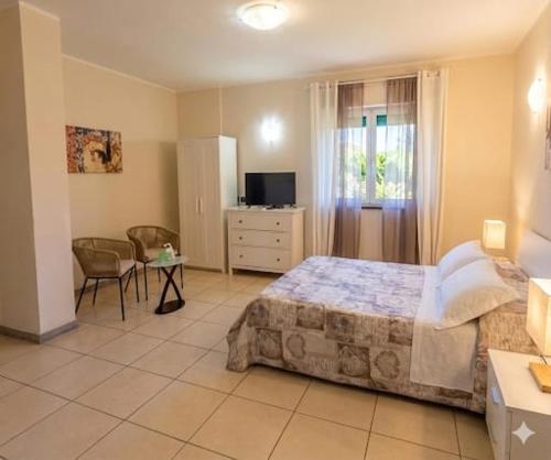 a bedroom with a bed and a table and a television at Villa Leilani B&B in Sale Marasino
