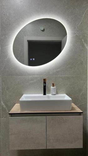 a bathroom with a white sink and a mirror at Luxury Villa Grey in Široki Brijeg