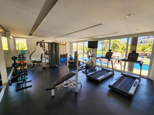 a gym with cardio equipment and a large window at Beach Living, Frente mar, Vizinho B Park - Oficial in Mangabeira