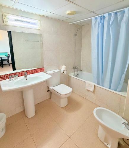 a bathroom with a sink and a toilet and a tub at Apartments Lloret Sun in Lloret de Mar