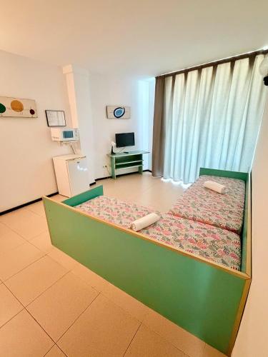 a bedroom with a green bed in a room at Apartments Lloret Sun in Lloret de Mar