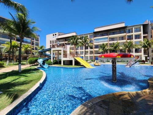 a resort with a pool with slides and a playground at Beach Living, Frente mar, Vizinho B Park - Oficial in Mangabeira