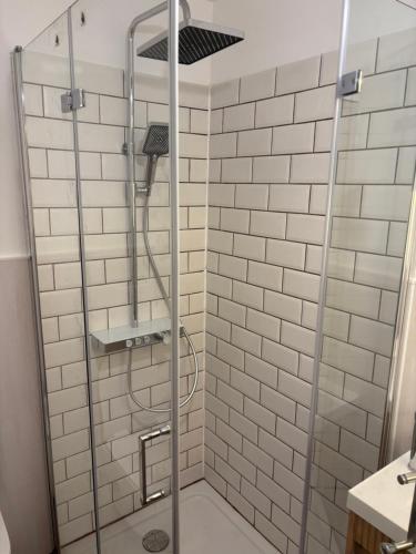 a shower with a glass door in a bathroom at Gasthaus zur Grenze in Cuxhaven