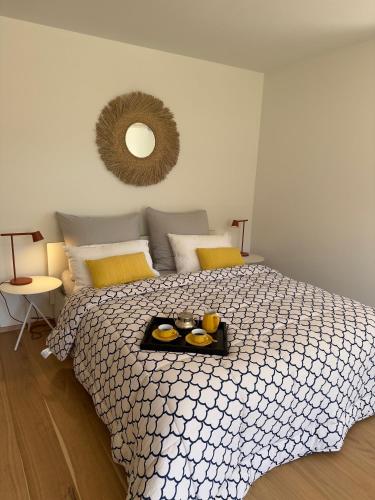 a bedroom with a bed with a tray of food on it at Maison Bleue Dreiländereck, Design Apartment mit Terrasse in historischem Landhaus nahe Basel in Kandern