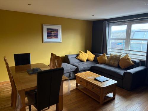 a living room with a couch and a table at Metro 8 Inverness City Centre in Inverness