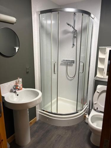 a bathroom with a shower and a sink and a toilet at Metro 8 Inverness City Centre in Inverness