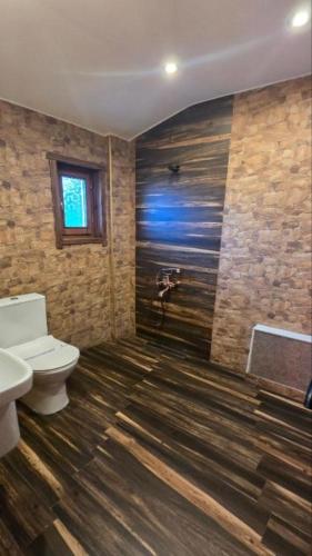 a bathroom with a toilet and a sink and a shower at Къща за гости Велчева Завера in Samokov