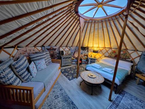 a bedroom in a yurt with a bed and a table at Rainbow's End Yurts in Dornoch