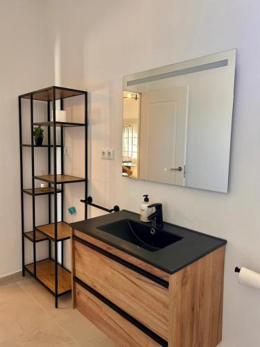 a bathroom with a sink and a mirror at Gaviota Beach Chiclana in Chiclana de la Frontera