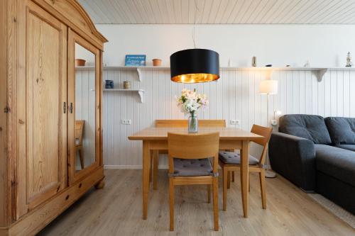 a dining room with a table and a couch at StrandMöwe in Burgtiefe auf Fehmarn 