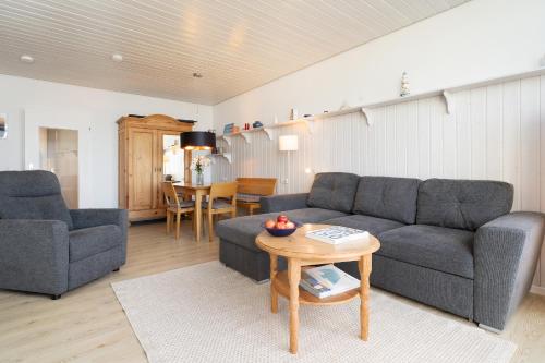 a living room with a couch and a table at StrandMöwe in Burgtiefe auf Fehmarn 
