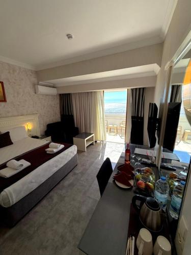a hotel room with a bed and a living room at Casa Fora Beach Resort Hotel - Spa & Aqua park - All Inclusive Plus Concept in Belek