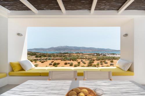 a room with two beds and a couch with a view at TWWO Antiparos in Antiparos