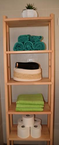 a wooden shelf with towels and a hair dryer at Apartmaji Grapa in Most na Soči