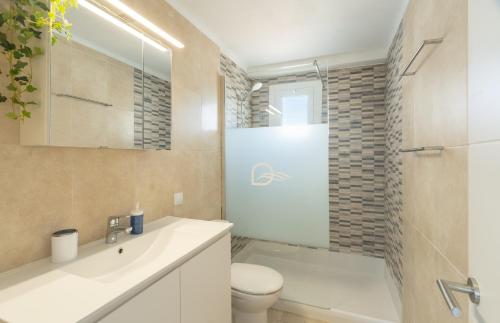 a bathroom with a sink and a toilet and a shower at DOLS MAR APARTMENTS in Camp de Mar