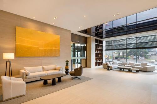 a living room with a couch and a table at Somerset Palace Seoul in Seoul