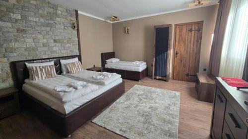 a room with a couch and a bed in it at Къща за гости Велчева Завера in Samokov