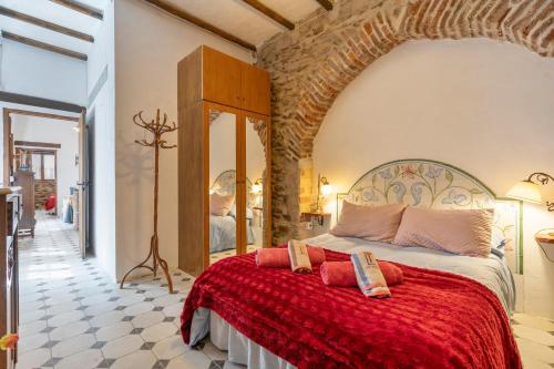 a bedroom with a large bed with a red blanket at Posada De Santiago in Rubite