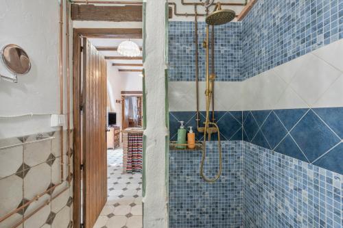 a bathroom with a shower with blue tiles at Posada De Santiago in Rubite