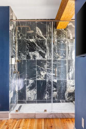 a bathroom with a glass walled shower at King Suite 4th Floor Downtown Hotel Boutique in Savannah