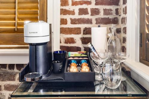 a coffeemaker sitting on top of a counter with food at King Suite 4th Floor Downtown Hotel Boutique in Savannah