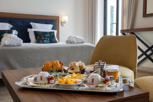 a tray of food on a table in a hotel room at Westminster Hotel & Spa Nice in Nice