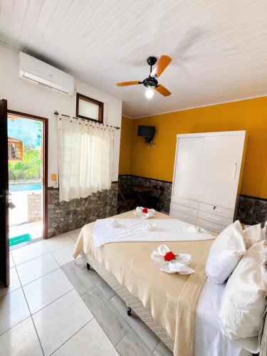 a bedroom with a bed and a ceiling fan at Pousada H&D in Angra dos Reis
