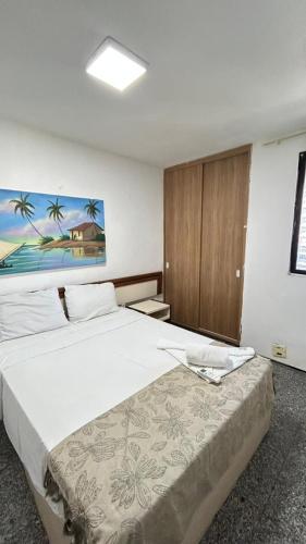 a bedroom with a large bed in a room at Flat Atlântico Neto in Fortaleza