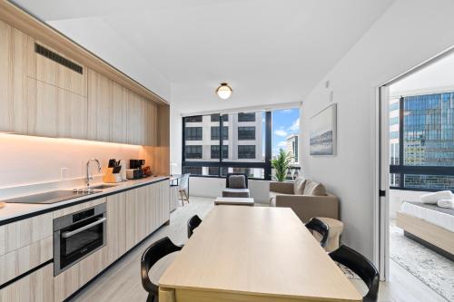 a kitchen and living room with a table and a couch at Downtown Miami Condo w Pool & Great Location in Miami
