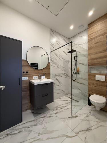 a bathroom with a sink and a toilet and a mirror at MeerZeit in Kappeln