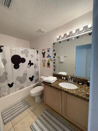 a bathroom with a sink and a toilet and a shower at Gone 2 Florida Vacation Homes in Orlando