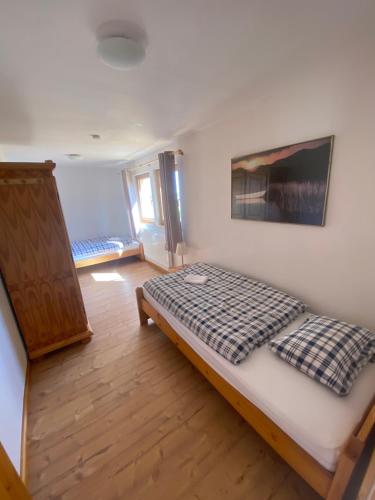 a bedroom with a bed with a checkered blanket at M1 Appartement in Uttenweiler
