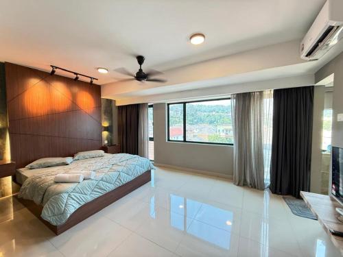a bedroom with a large bed and a large window at Walnut Grove Premium Pool Villa in Batu Caves