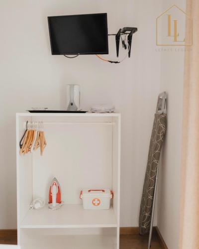 a white shelf with a tv on a wall at Casa do Foral by Lethes Legacy in Ponte de Lima