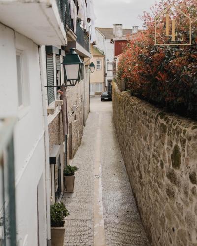 a narrow alley with plants on the side of a building at Casa do Foral by Lethes Legacy in Ponte de Lima
