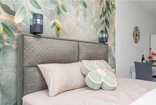 a bed with two pillows on top of it at Apartmani Olga in Stari Bar