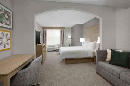 a hotel room with a bed and a couch at Holiday Inn Santee by IHG in Santee