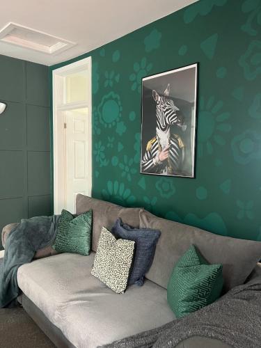 a living room with a couch and a zebra picture at The Hive 2-Bed Apartment with Kitchen and Private Bathroom in Lively Monton Village - Sleeps 4 - Free WiFi - Parking Nearby in Manchester