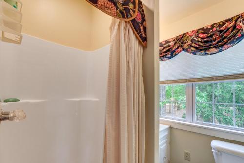 a bathroom with a shower curtain and a window at Pool Access! Cozy Couple's Getaway in Kilmarnock in Kilmarnock