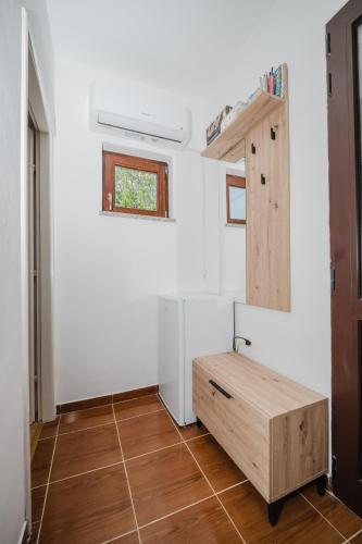 a tiny house with a wooden bench in a room at Apartman Mimi - Pula airport in Pula