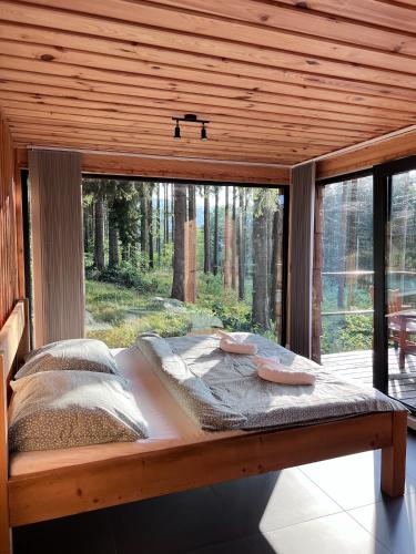 a bed in a room with a large window at Berry in Klatovy