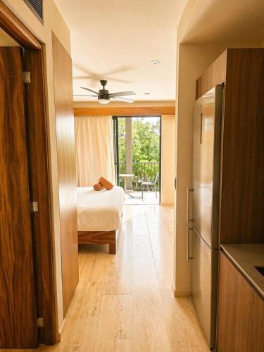 a bedroom with a bed and a door to a room at Tuk Hacienda Studio Rooftop Pool Padel TUK in Tulum