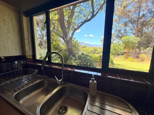 a sink in a kitchen with a window at Franschhoek farm off the grid in Franschhoek